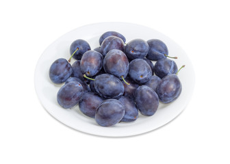Plums on a white dish