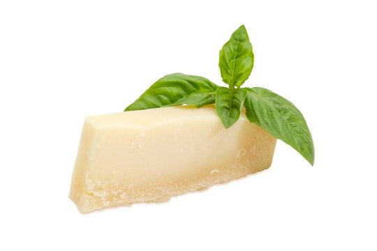 Parmesan cheese with basil twig on a white background