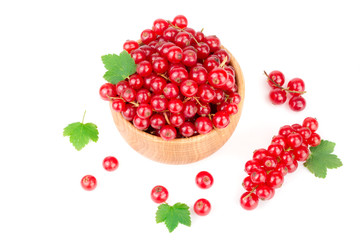 Red currant berries in a wooden bowl with leaf isolated on white background