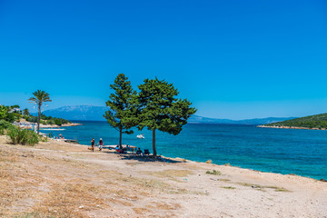 Cesme, Turkey - July 07, 2017 : People swimming and sunbathing  at Sifne Beach