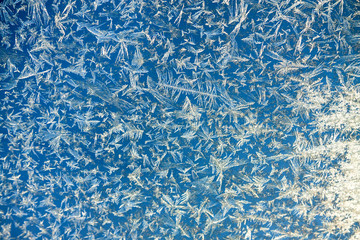 abstract blue  a white background from frosty pattern at a frosted window.