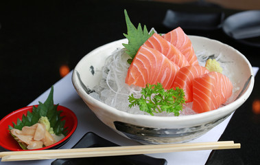Sliced salmon raw sashimi on ice.