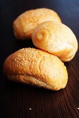 Wheat roll with sesame seeds on dark background