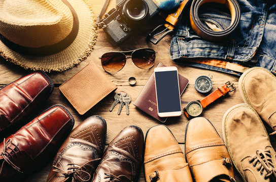 Shoes for men various styles and Travel accessories costumes. Passports, luggage, The cost of travel maps prepared for the trip on a wooden floor - lifestyles. - Powered by Adobe