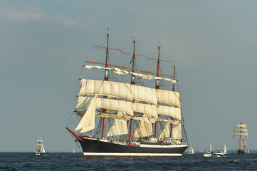 Tall Ship under sail with the shore in the background