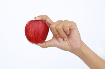 Close up of female hand holding red apple. Isolated on white.