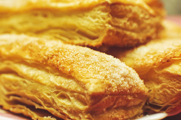Puff pastry cakes with sugar powder close up