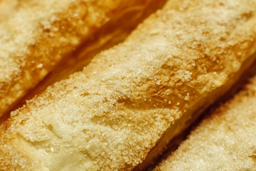 Puff pastry cakes with sugar powder close up