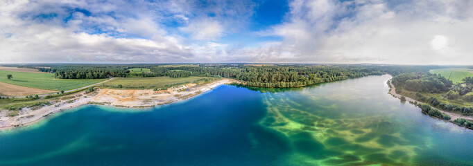 Panorama from aerial pictures of a big lake after a gravel dismantling