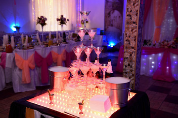 A pyramid of champagne glasses at the wedding.