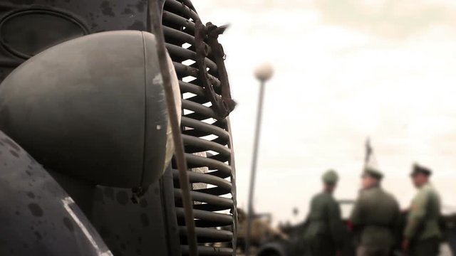 World War Two - Close up of German supply truck with officers in background