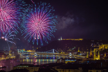 Budapest, Hungary - 20th of August fireworks over the river Danube on St. Stephens or foundation day. This view includes the Liberty Statue, Gellert Hill, Citadell and the Szechenyi Chain Bridge