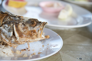 Head Skeleton of fried fish on dish, It's Delicious food