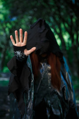 Fototapeta na wymiar Photo of witch in hood