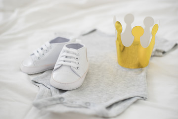 Baby boy prepare suit and shoes with paper gold crown.