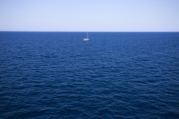 Fototapeta premium Sailing boat on horizon