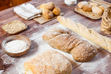 Freshly baked delicious bread on a rustic wooden table, healthy eating concept