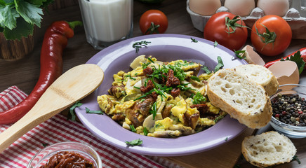 Scrambled egg with dried tomatoes and home baked goods
