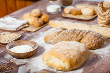 Freshly baked delicious bread on a rustic wooden table, healthy eating concept
