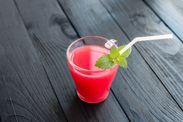 Watermelon juice on a wooden table. It can be used as a background