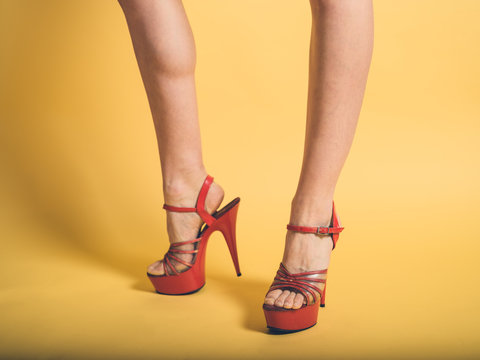 Woman in red stripper heels on yellow