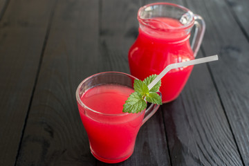 Watermelon juice on a wooden table. It can be used as a background