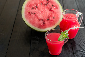 Watermelon juice on a wooden table. It can be used as a background