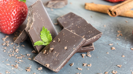Dairy and bitter chocolate with strawberries and mint leaves