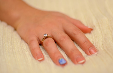 Photo of hand with wedding ring with diamond on white background