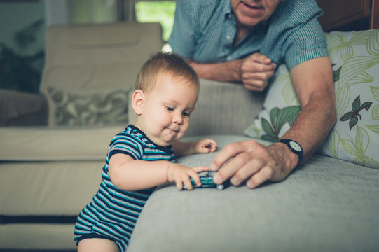 Grandfather playing with baby grandson