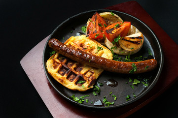 juicy sausage grill on a beautiful pan with vegetables

