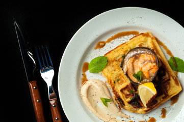 roasted trout on a pillow of bread with sauce and vegetables
