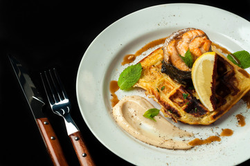 roasted trout on a pillow of bread with sauce and vegetables

