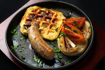 juicy sausage grill on a beautiful pan with vegetables
