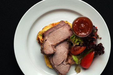 Pork steak with vegetables and garnish
