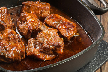 Pork spare ribs on dish in own sauce