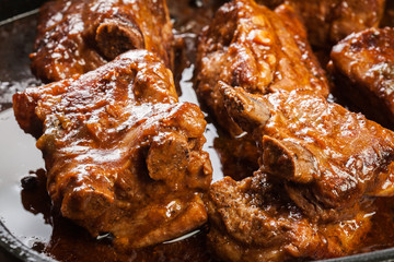 Pork spare ribs on dish in own sauce
