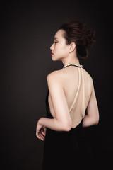 Fototapeta premium Beautiful woman portrait on black background. Young lady posing with gorgeous make up and hairstyle.