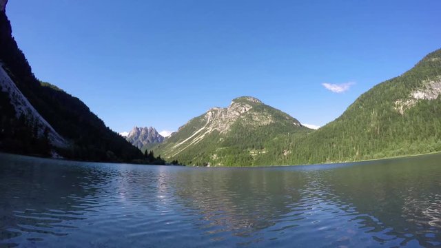 4K. Sunset at amazing alpen lake, time lapse with deep mooving shadows. Predil Lake (Lago Del Predil), alps mountains, Italy, Europe. 