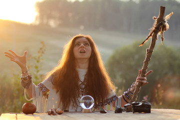 witch with crystal ball at sunset