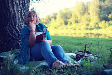 woman lay and read book sun