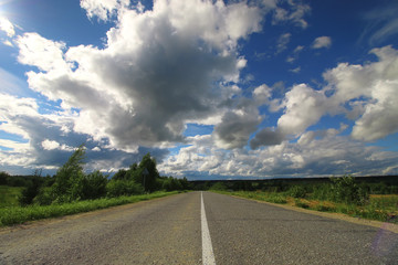 Fototapeta premium road in the field cloudy landscape