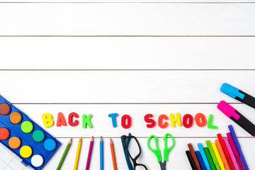 School supplies on white wooden table. Back to school concept