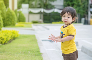 Closeup naughty asian kid play in the public park background with copy space