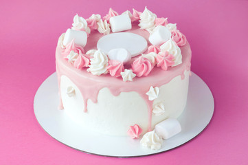 Birthday pink cake for girl, decorated with marshmallow, meringue cookies on a pink background. Cutout. Picture for a menu or a confectionery catalog.