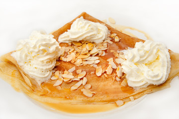 Traditional authentic French crepes with ice cream and almond topping
