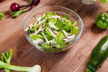 vegetable green salad bowl on kitchen table, balanced diet