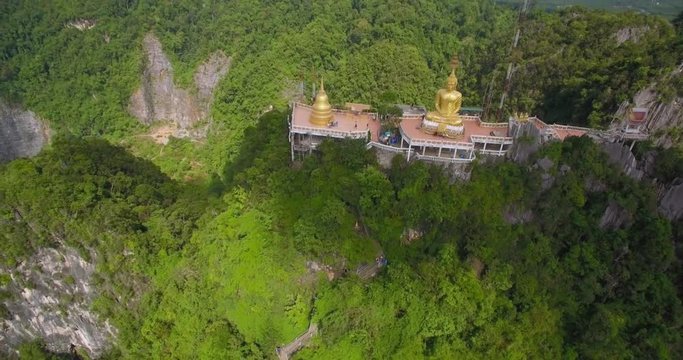 Buddhist Statue on Mountain Top at Wat Tham Sua, Krabi, Thailand, Aerial Pullback Shot
