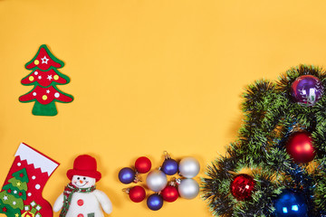 Flat lay of Christmas decoration on yeallow background