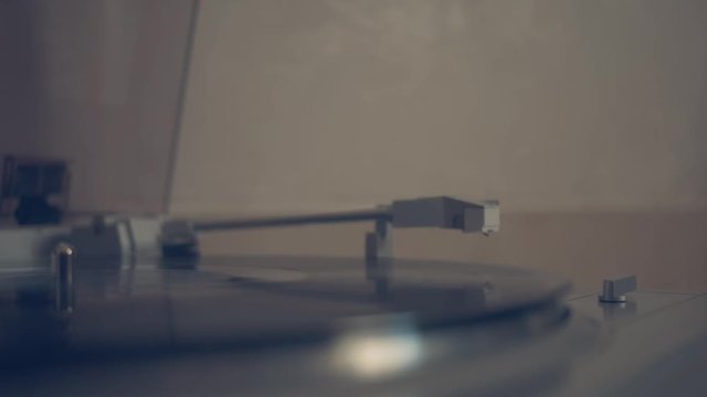 Close up of a record player playing vinyl. Retro vinyl turntable playing a black 33 rpm vinyl record. 4k footage